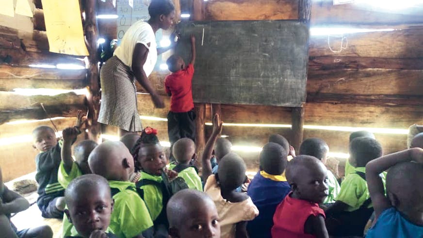 Jacob-schrijft-cijfers-op-het-schoolbord-Oeganda- families versterken