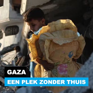 Een jongen met deken en kussen op de vlucht in Gaza