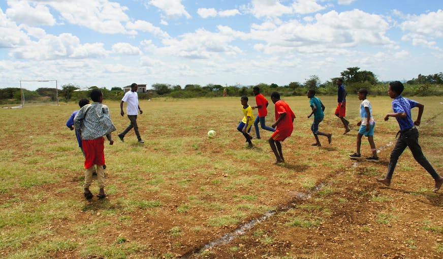 De kinderen zijn als TeamUp activiteit aan het voetballen