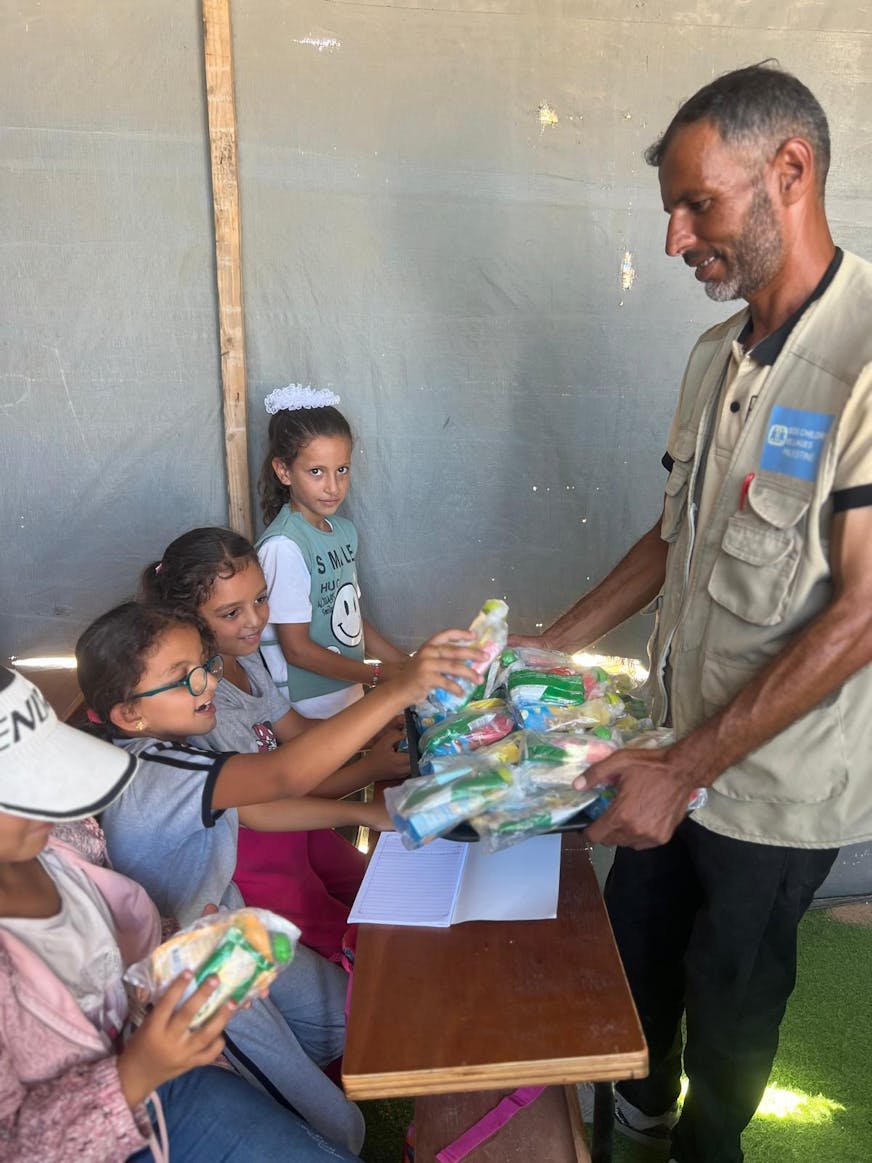Leraar in Gaza met kinderen in schoolbanken